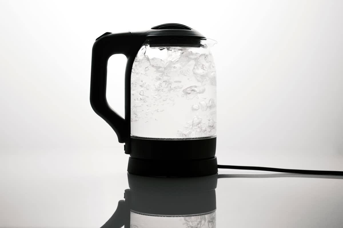 A glass electric kettle boiling water