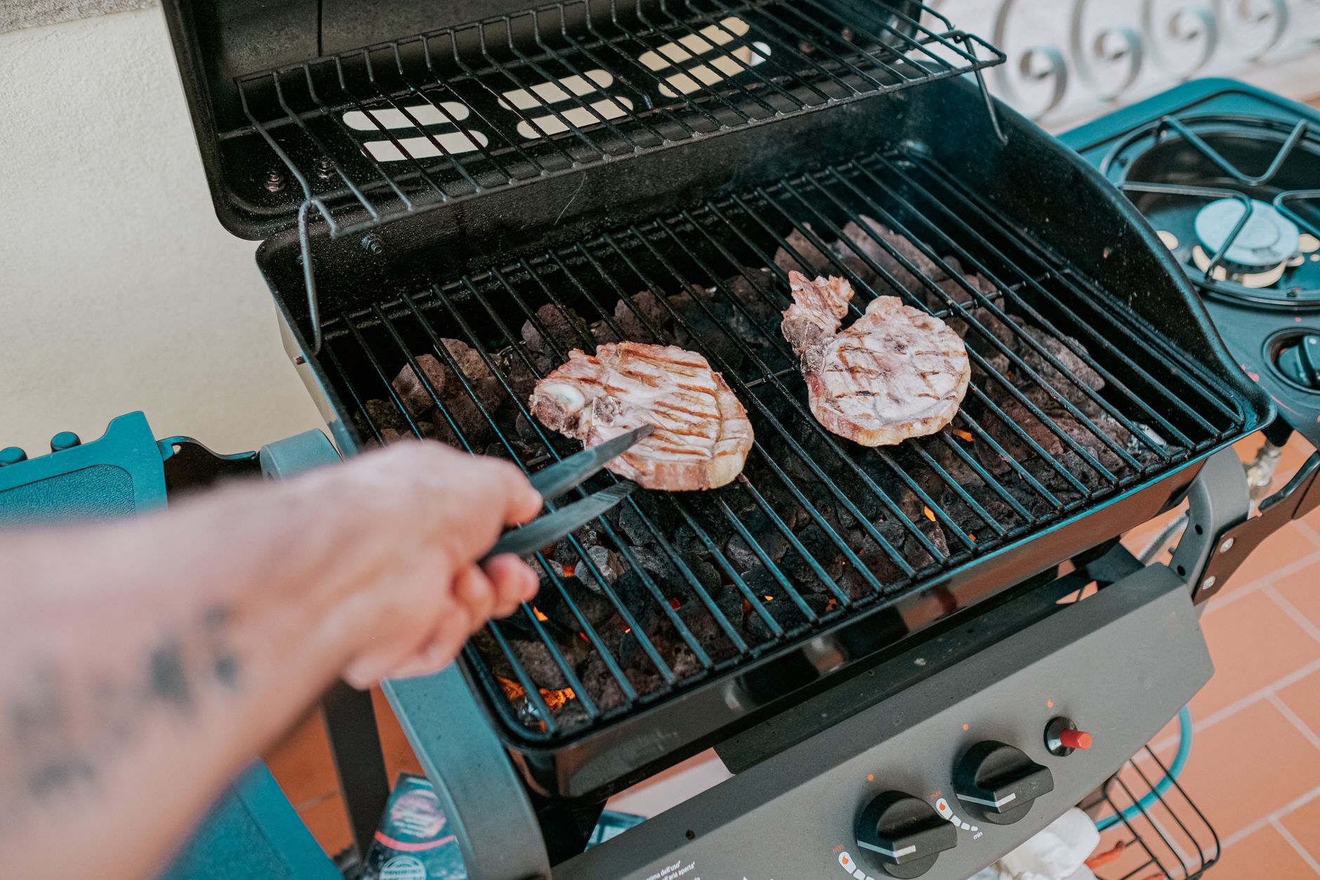 Grill outside, well away from the house and railings.