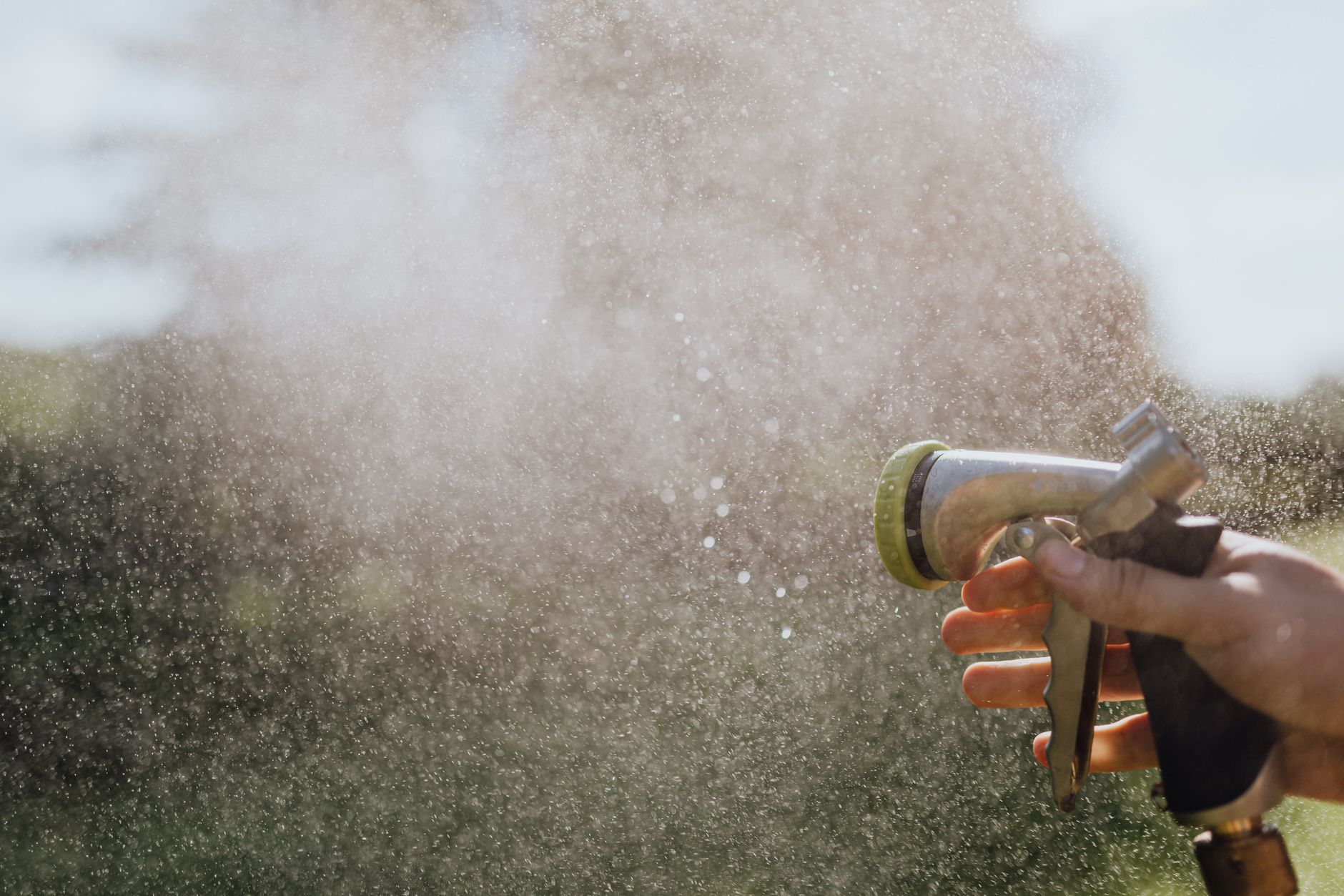 A garden hose being disconnected and drained for winter